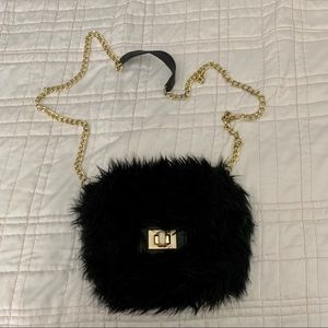 Black faux fur mini crossbody bag.